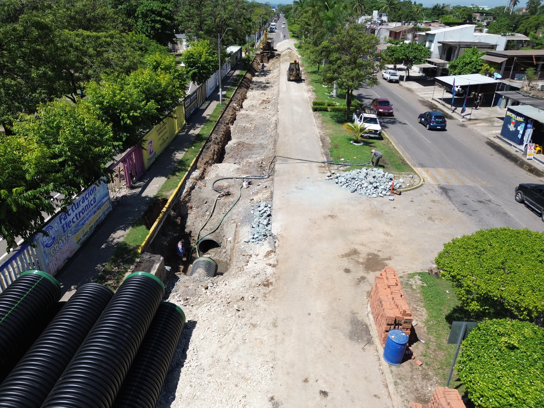 Corrugated culvert pipes beside active trench excavation