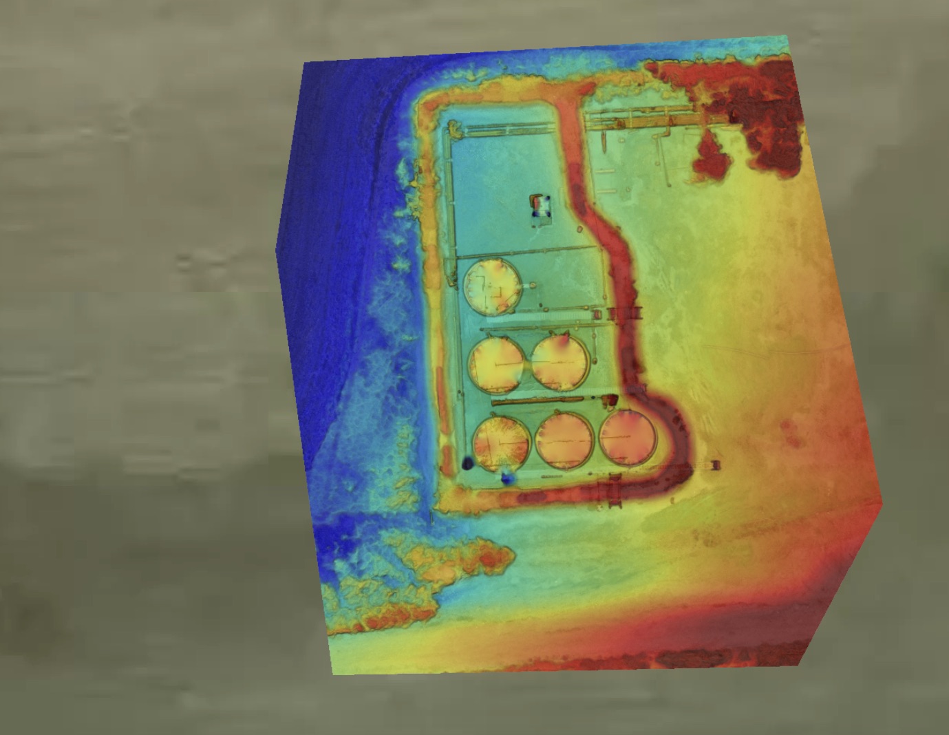 Colorized elevation surface over a tank containment pad and berms.