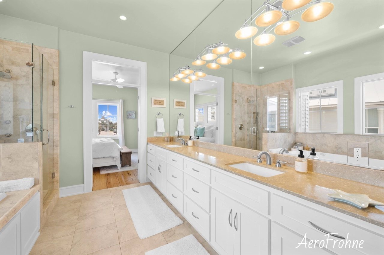 Spa-style bathroom with double vanity, large mirrors, and modern lighting