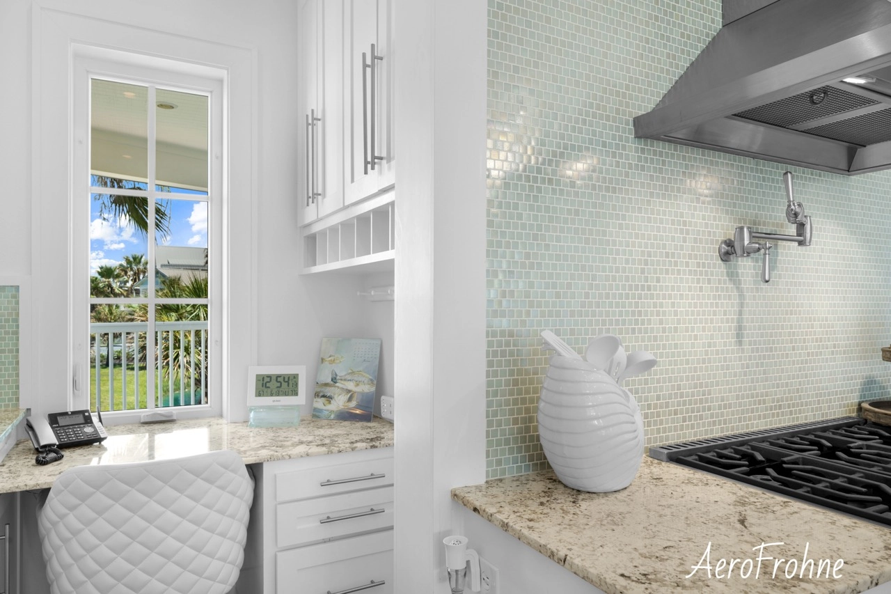 Gas cooktop with pot filler and mosaic tile backsplash