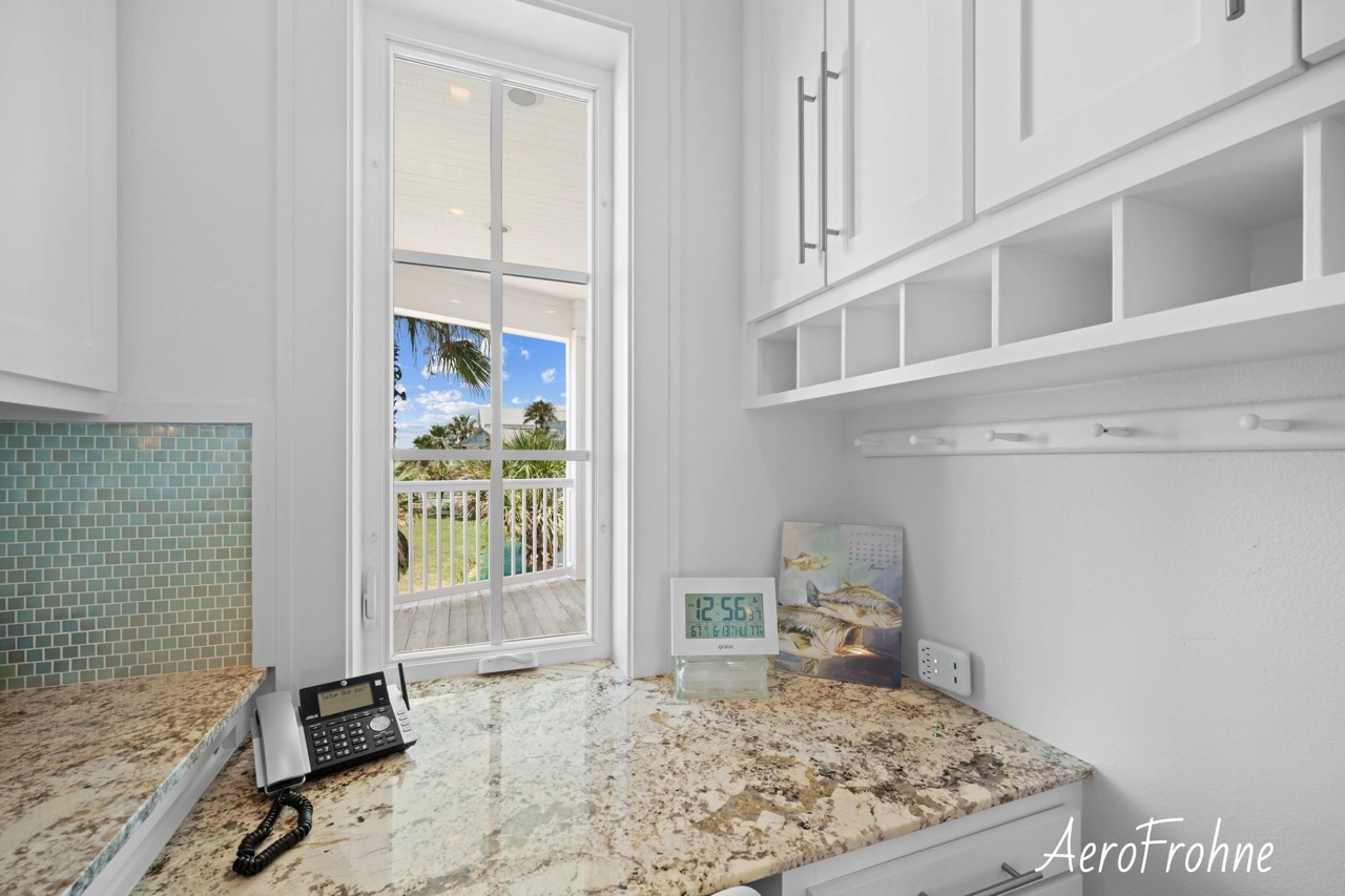 Kitchen desk nook with built-in cabinetry and window