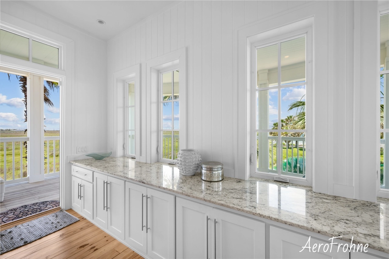 Kitchen window counter with built-in cabinetry and multiple windows