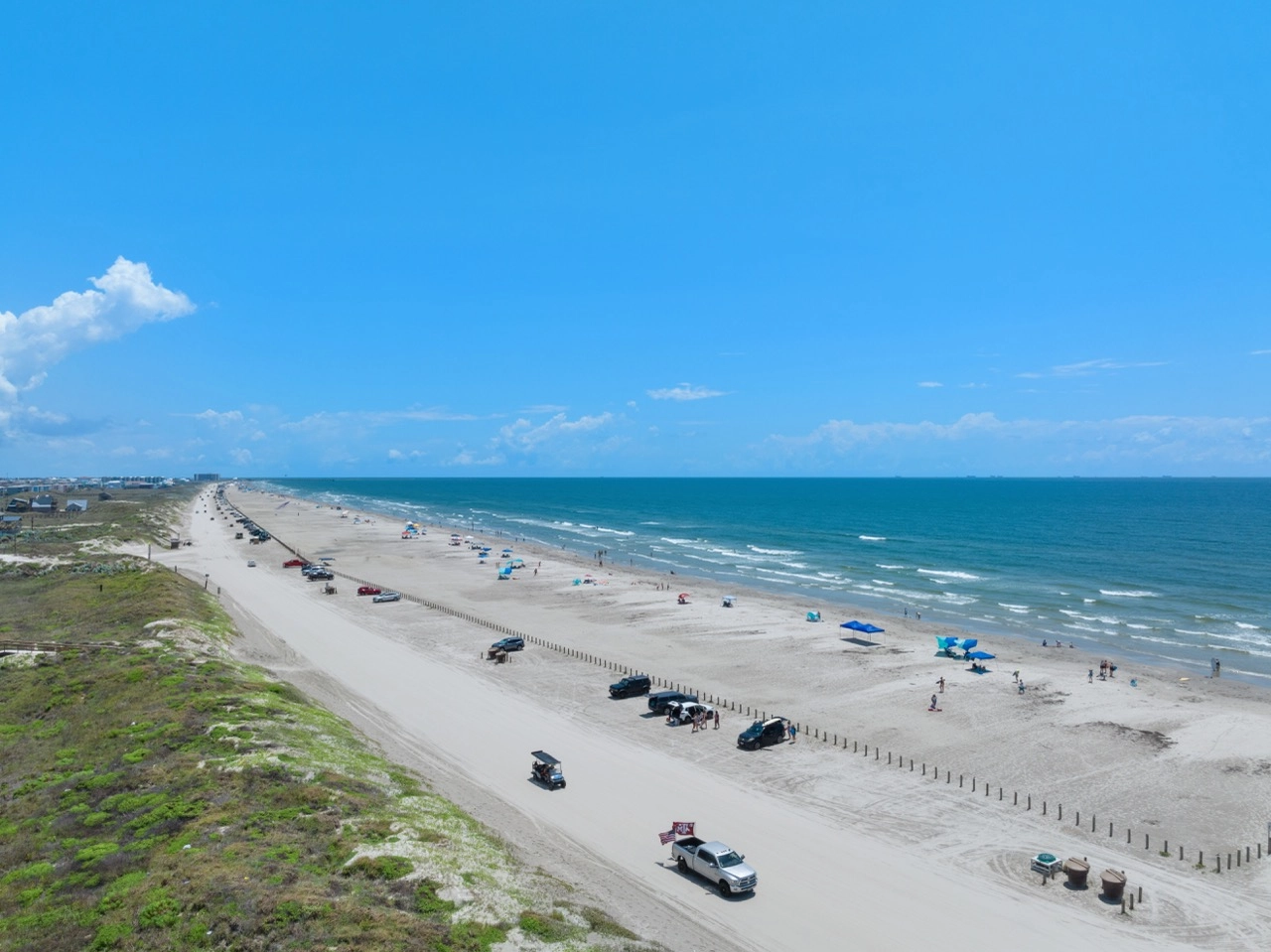 Elevated coastline view showing beach, dunes, and Gulf water