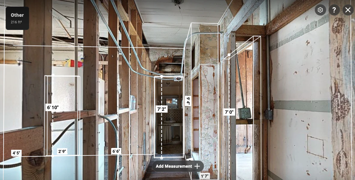 Exposed wall corridor view showing wall spans, doorway heights, opening widths, and the 216 ft² area context.