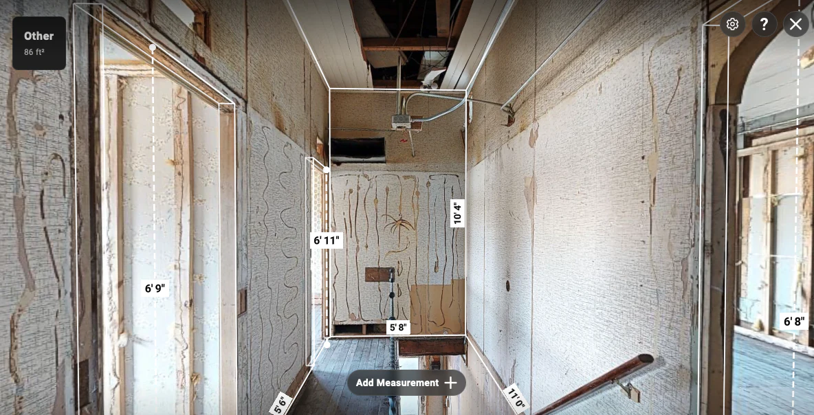 Narrow upper level passage showing doorway heights, wall spans, and an 86 ft² area context near the stair opening.