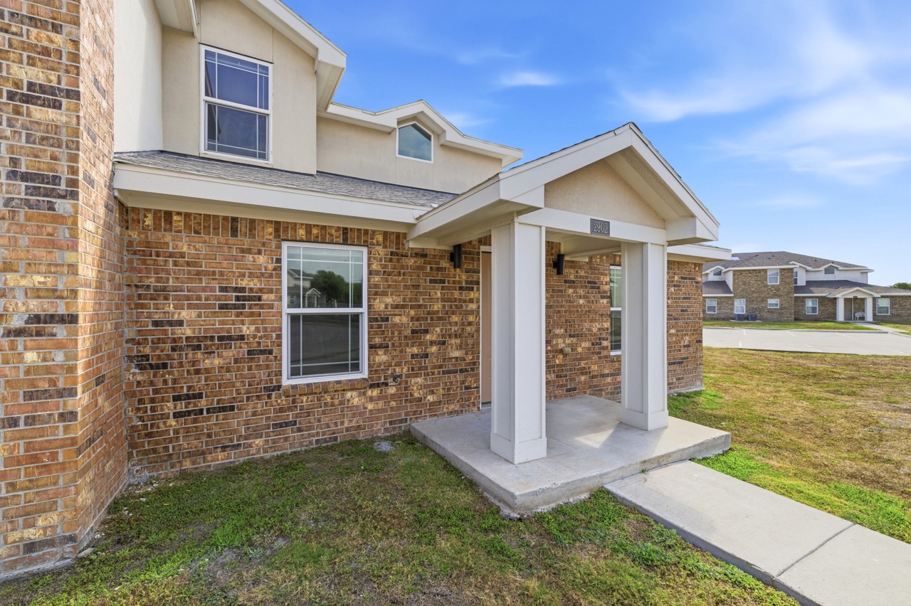 Exterior entrance to a modern clubhouse office building with column portico, Portland, Texas