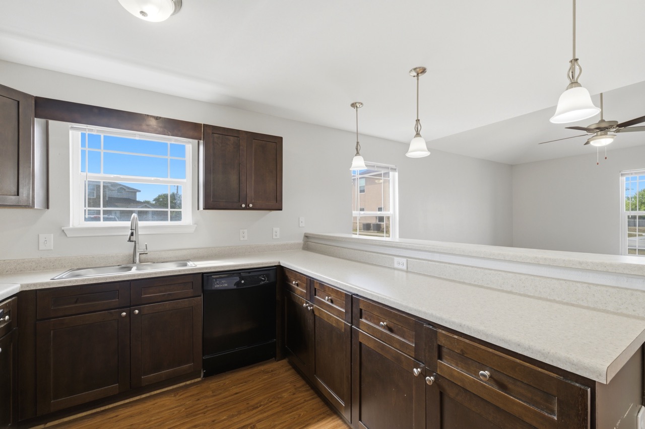 Modern kitchen focusing on dark cabinetry and a window view, Portland, Texas
