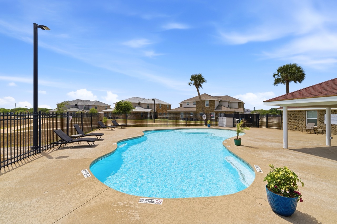 Community amenity area with large in-ground swimming pool and lounge seating, Portland, Texas