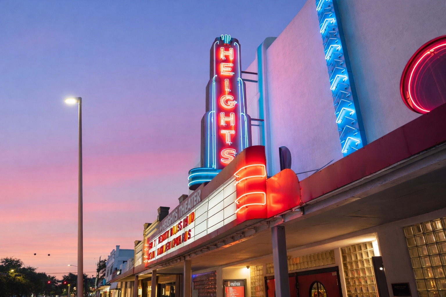 Neon marquee of the historic Heights Theater in Houston at dusk, showing vintage architecture