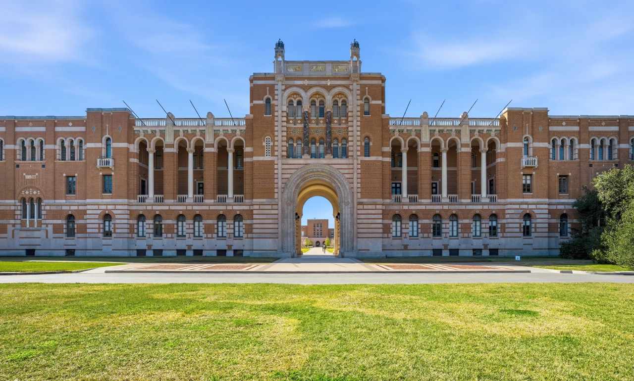 Symmetric front view of Lovett Hall administration building at Rice University in Houston, featuring iconic brick architecture and arches