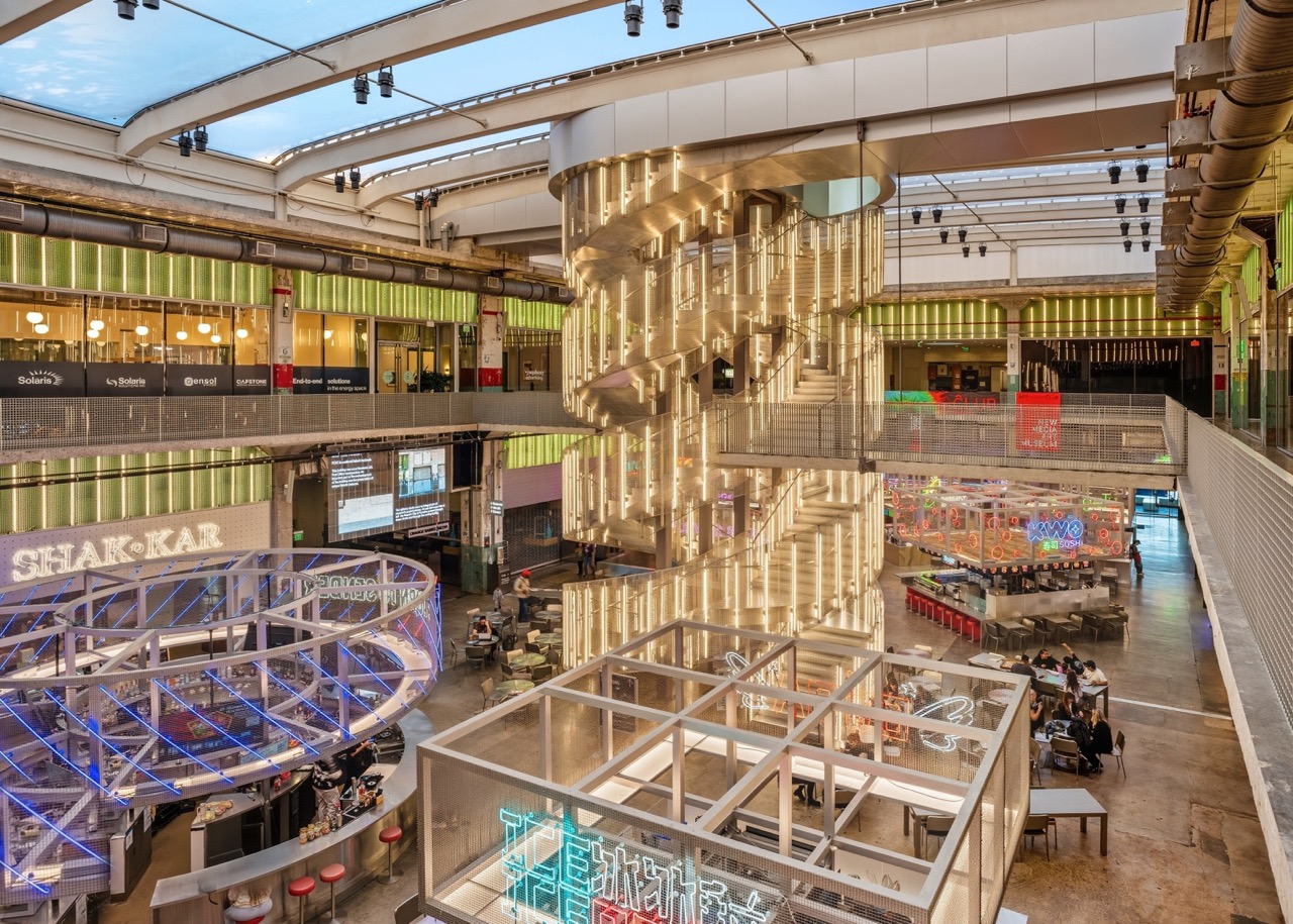 View down into a multi-story common atrium of a modern Houston structure, featuring geometric lighting