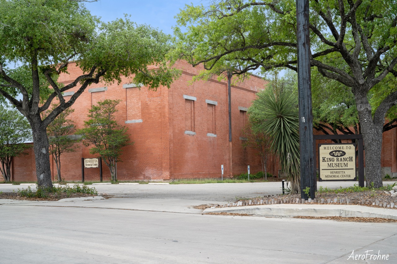 Exterior view of the historic red brick building housing the King Ranch Museum in Kingsville, Texas.