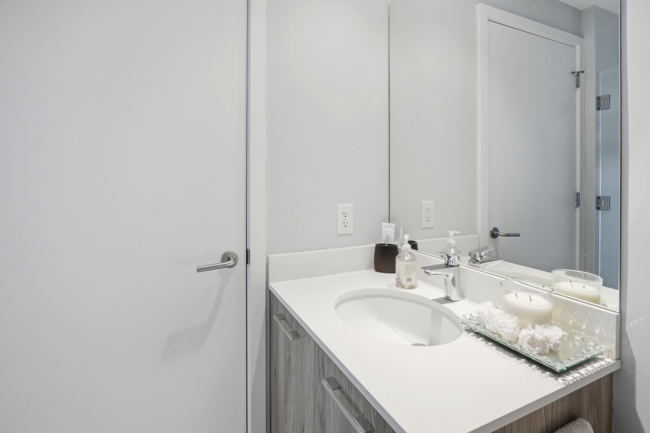 Close-up of modern bathroom vanity with white countertop.