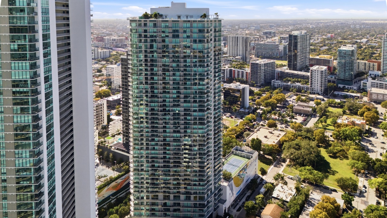 Aerial view of rooftop tennis courts and pools in the Paraiso District, Edgewater.