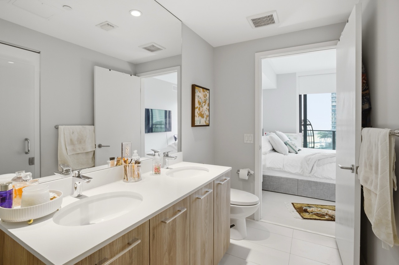 View from the bathroom vanity looking out into the bright master bedroom.