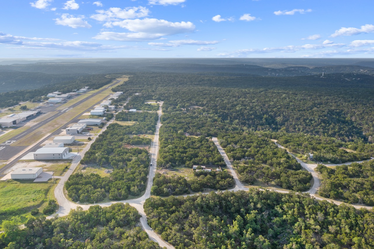 Aerial view of a rural landscape with a road and scattered houses in Lago Vista Texas