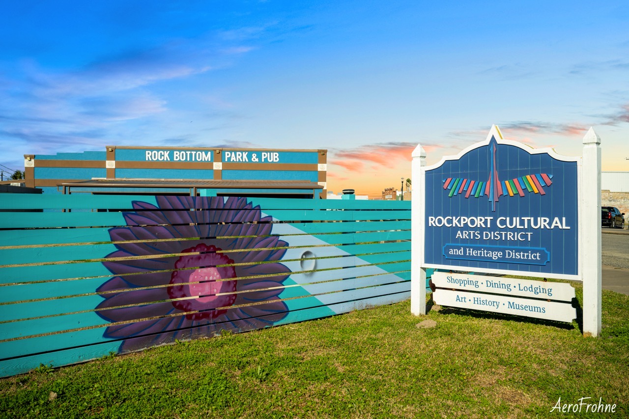 A mural and sign for the Rockport Cultural Arts District