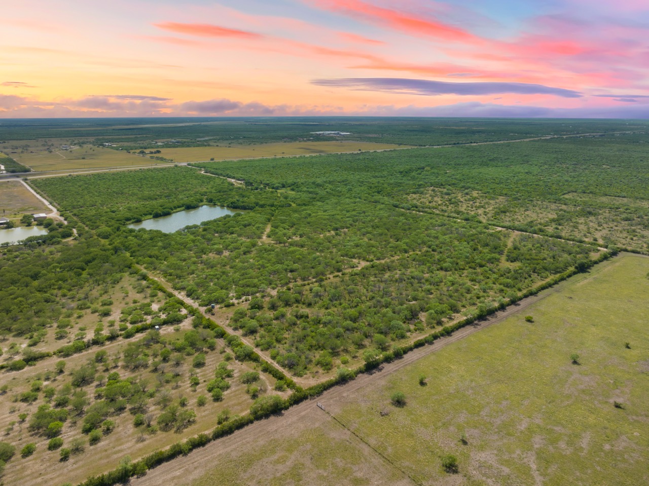 Aerial view of vast ranch land at sunset in Alice Texas