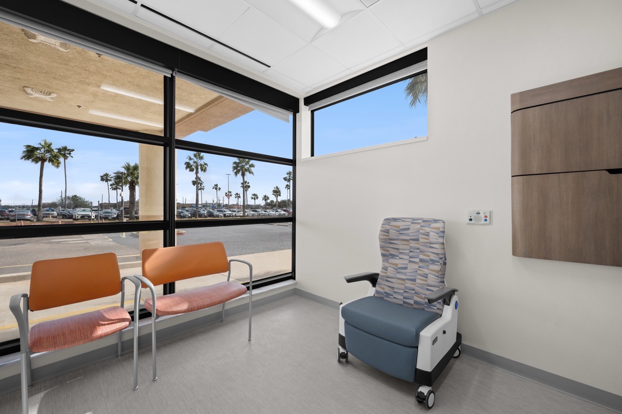 A small clinic waiting area with chairs and a window