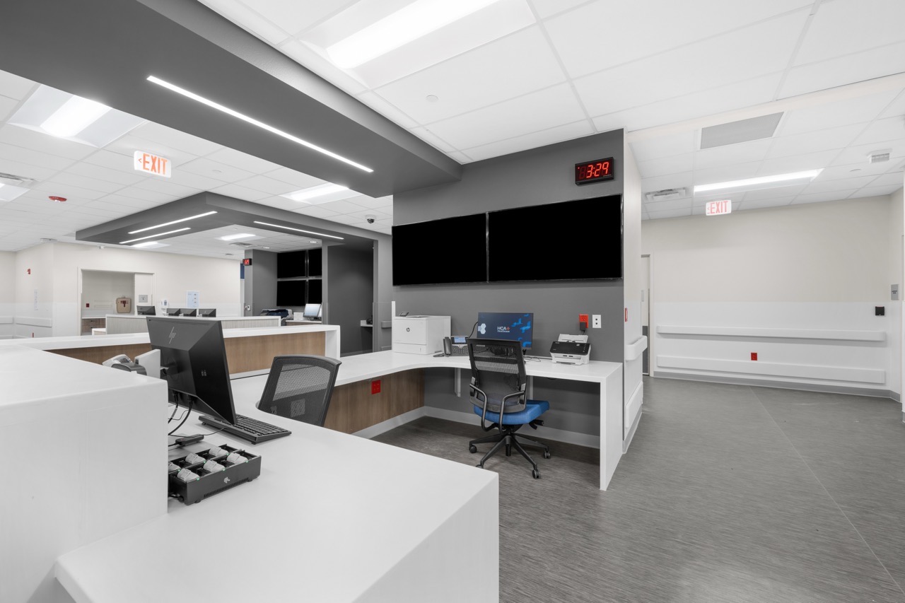 The interior of a nurse's station showing desk space and monitors