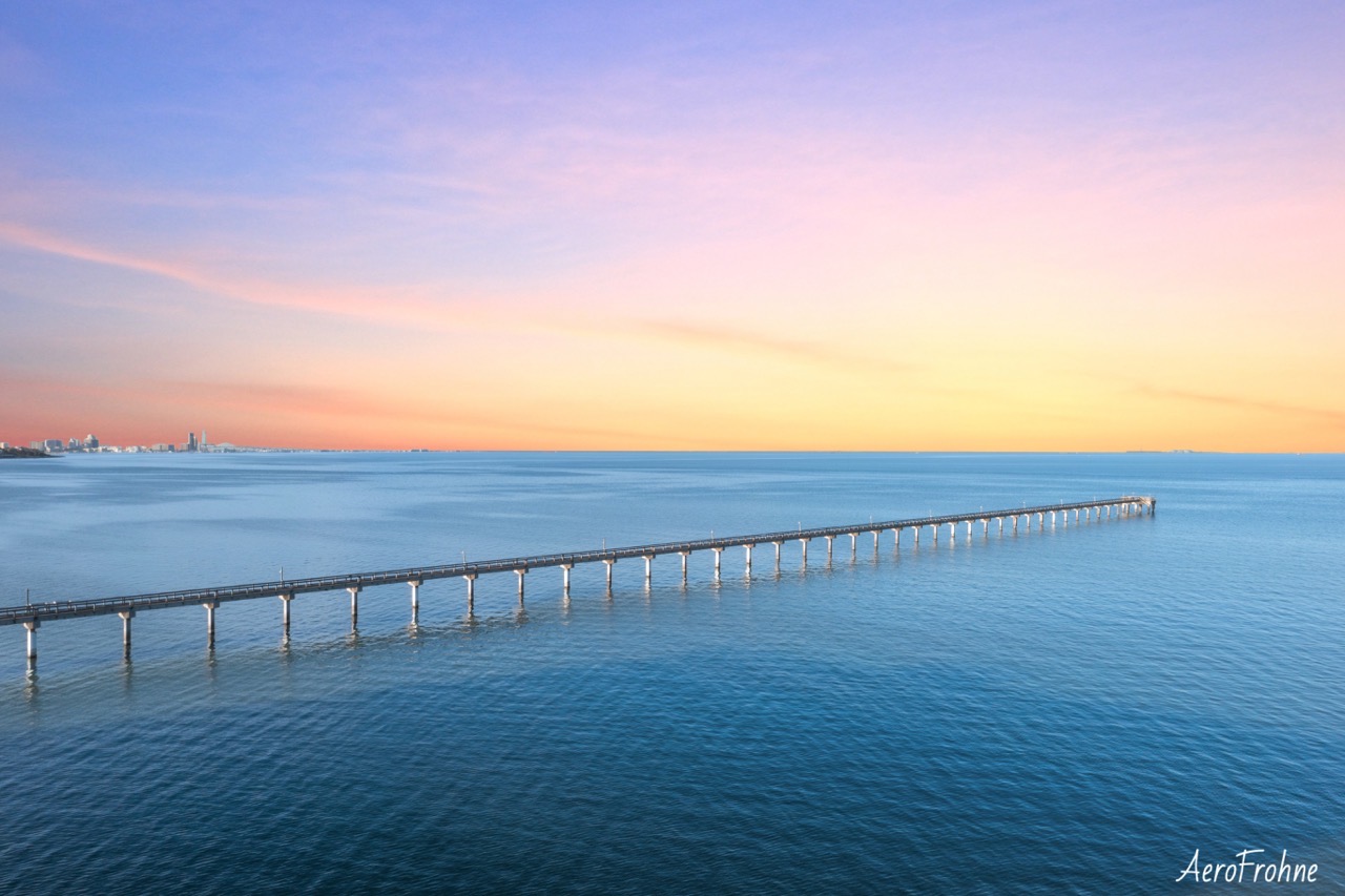 A long pier stretching into the bay at sunrise in Corpus Christi Texas