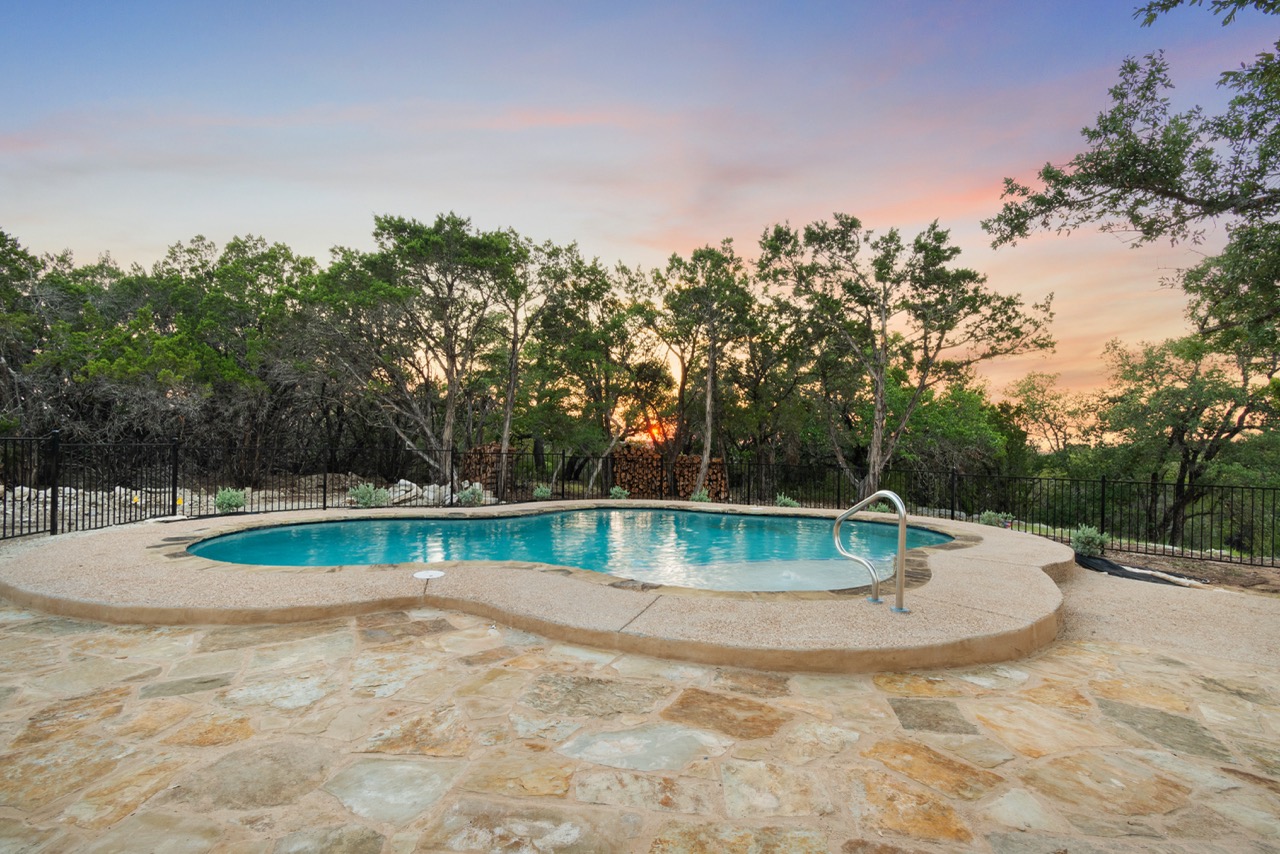 Exterior backyard pool at sunset