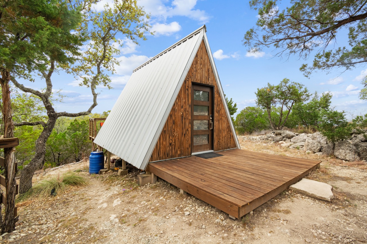 Exterior A-frame cabin with wood siding