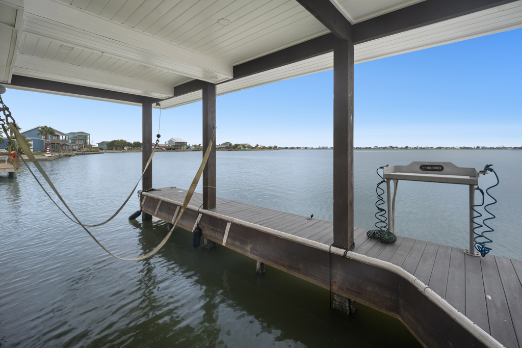 Covered boat lift and dock on the canal