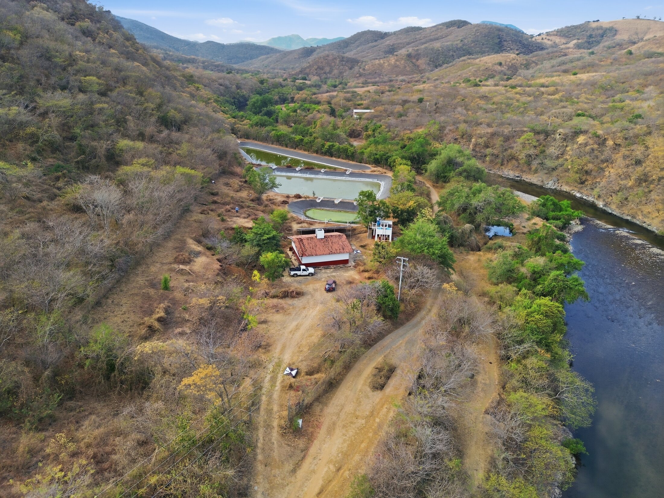 Aerial infrastructure survey of ponds, buildings, roads, and river