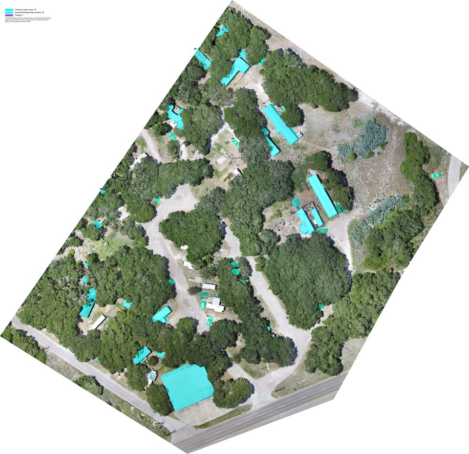 Aerial orthomosaic with cyan instance masks separating visible road vehicles and fixed roof buildings